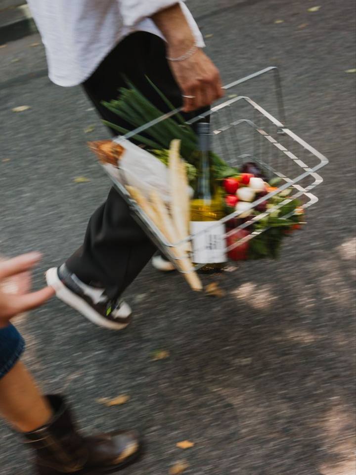 Someone carrying a basket of produce home along the street